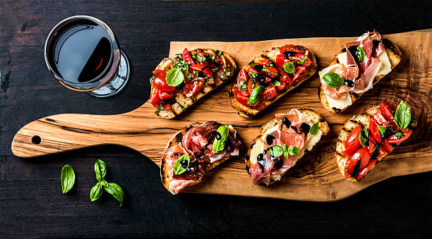 brushetta set and glass of red wine. small sandwiches with - baguette vinegar balsamic vinegar glazed imagens e fotografias de stock