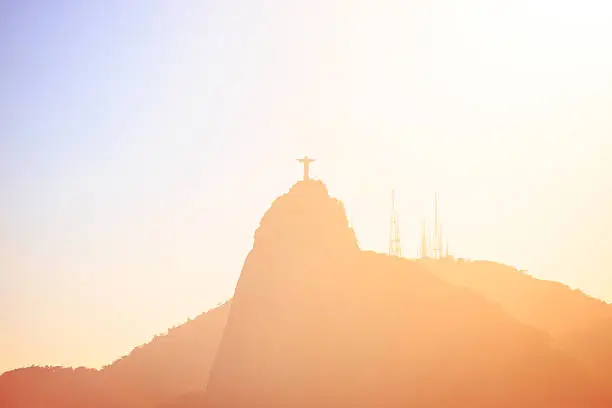 evening hills with statue of Jesus at Rio de Janeiro abstract shot at sunset time