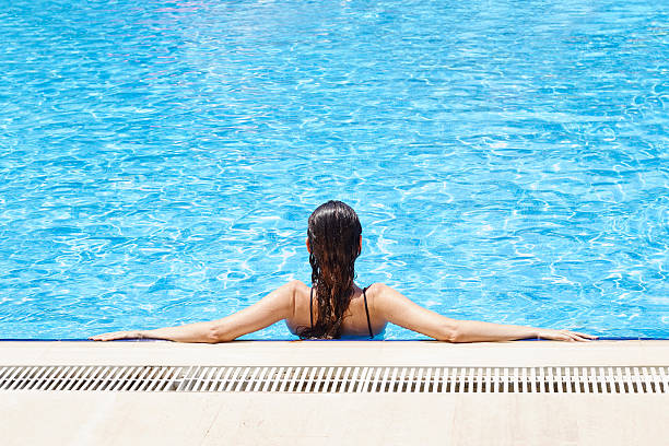 istock Woman Relaxing at a Resort Swimming Pool 544724580
