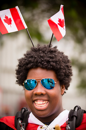Richmond, British Columbia, Canada - July 1, 2016: A smiling young adult in costume celebrating the Canada Day festivities during a parade held in Steveston village located near Vancouver in Richmond, British Columbia, Canada.