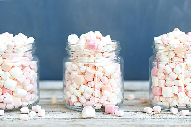 Three glass jars filled to the brim marshmallow