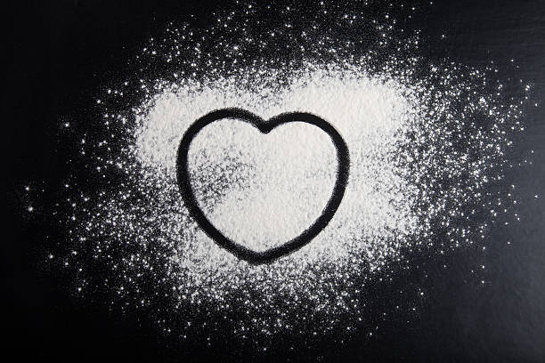 istock Shape of heart drawn on the flour on black background 544733080