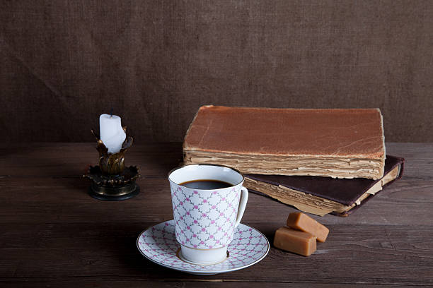 istock Old books, cup of coffee, candy and ancient candle 544733206