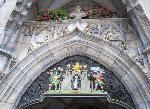 The Coat of arms of Munich over the doorway of the the Neues Rathaus (New Town Hall) at the Marienplatz Square in Munich, Bavaria, Germany features the Benedictine monk from which the city takes its name.