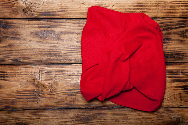 istock Red kitchen towel on old wooden burned table or board 544735670