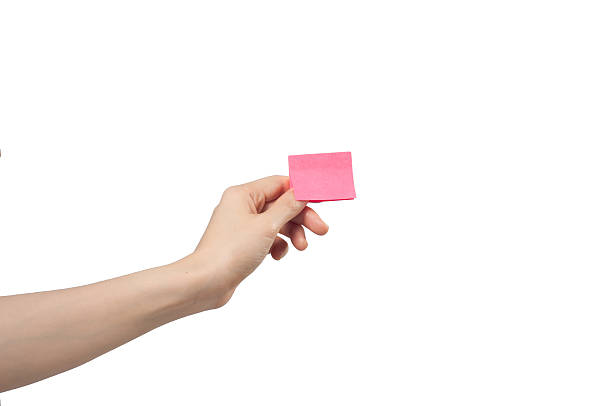 hand holding note paper. hand holding note paper on white background. left handed catcher stock pictures, royalty-free photos & images