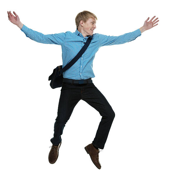 istock Smiling casual man jumping with arms outstretched 544739104