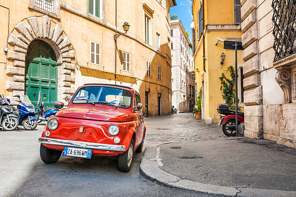 Rome, Italy - May 2, 2016: Red vintage Fiat Nuova 500 parked in the old street in Rome.
