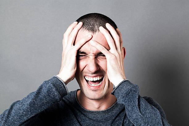 istock angry young man holding his head, screaming his burnout 544740676