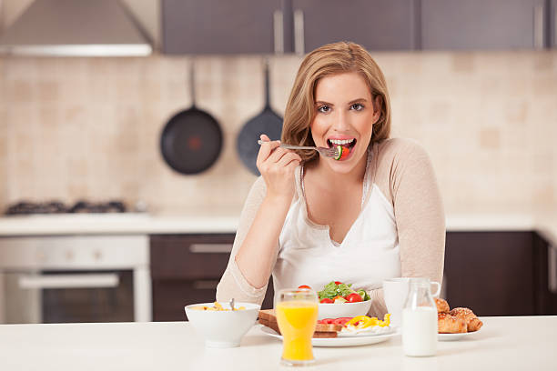 istock Beautiful woman eating breakfast. 544740826