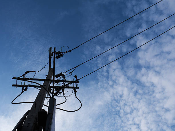 istock electric pole power lines and blue sky with lamp 544745674