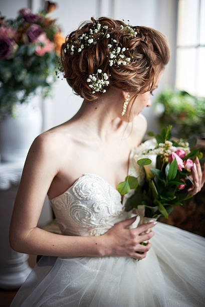 istock Young attractive bride with flowers 544747464