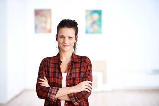 Portrait of young beautiful designer with arms crossed