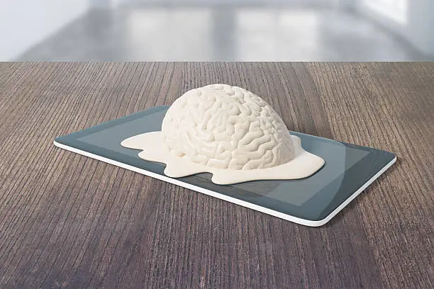 Mental degradation concept with brain melting on tablet placed on dark wooden desktop. 3D Rendering