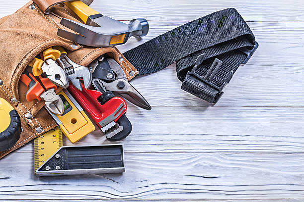 istock Leather building belt with construction tools on wooden board di 544750632