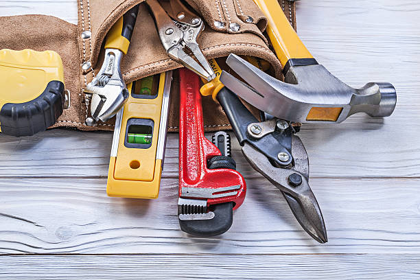 istock Tool belt pliers construction level tape line claw hammer pipe 544750768