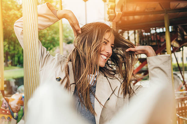 Young woman having fun ride on a carousel. Shot made during Istockalypse Paris 2016 event.