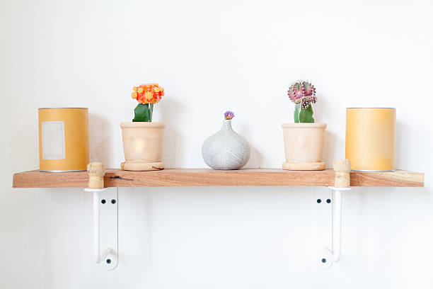 istock flowers and cup on a white wall shelf 544751846