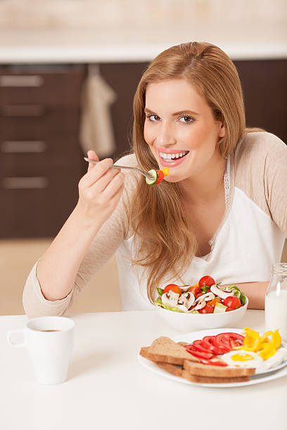 mujer comiendo comida nutritiva. - women spoon tasting elegance fotografías e imágenes de stock