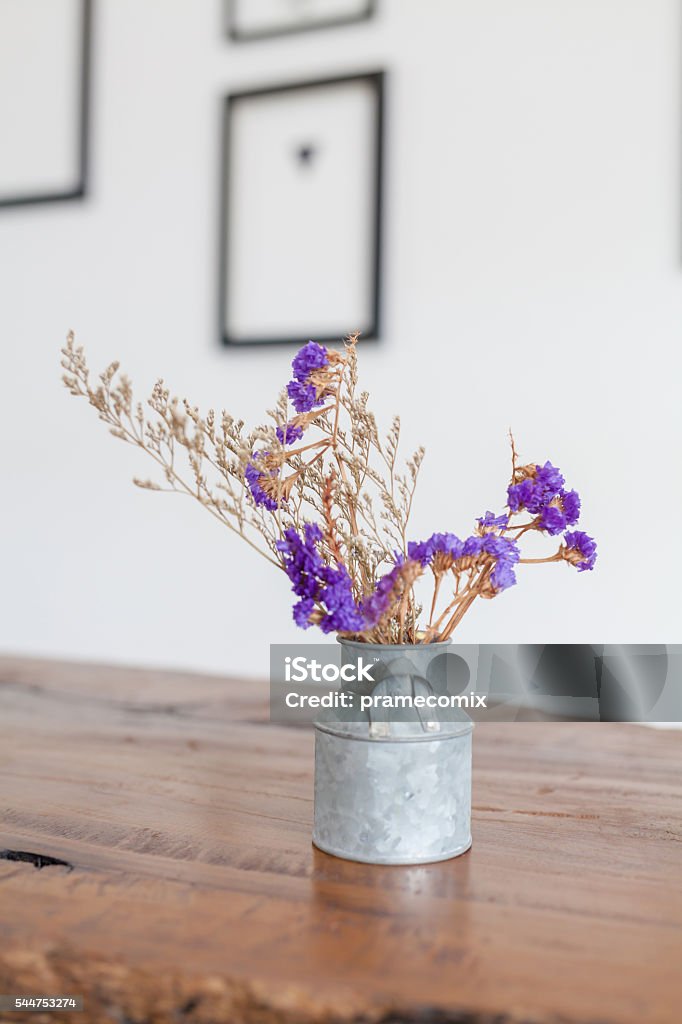 flowers bouquet on shelf in front of wooden wall Backgrounds Stock Photo