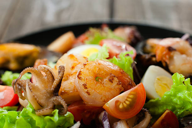 istock Grilled shrimp,octopus,quail egg in salad closeup 544789606