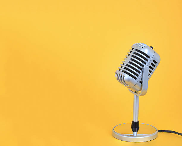 istock Retro microphone Vintage silver  with yellow background. 544789846