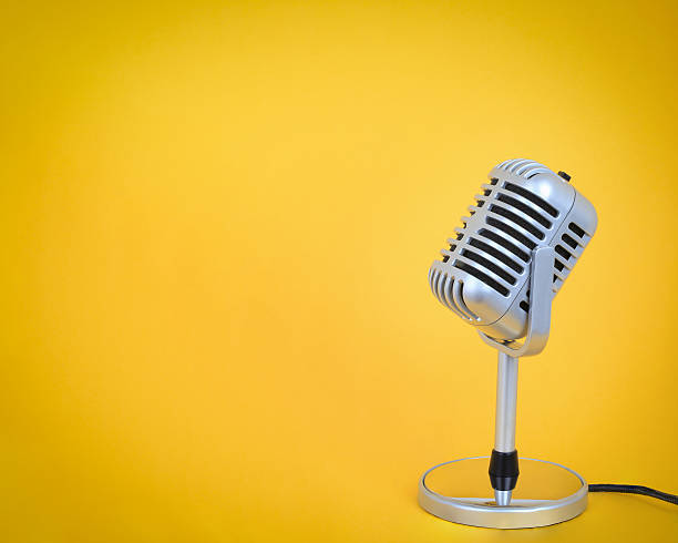 istock Retro microphone Vintage silver  with yellow background. 544789960