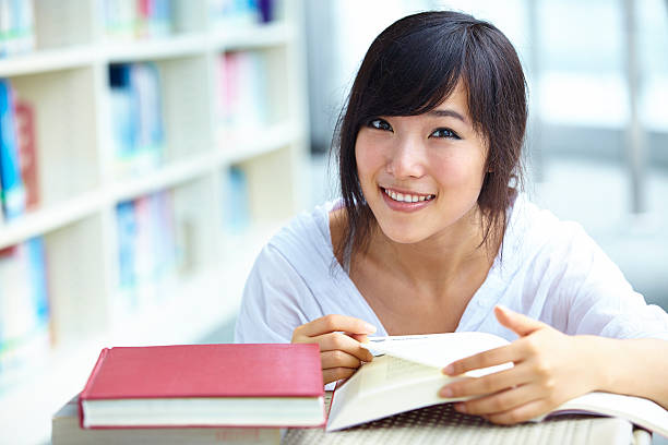 istock pretty Asian college student in library 544790296