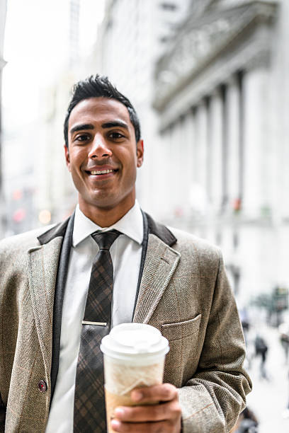 istock Businessman with coffee mug on wall street 544794170