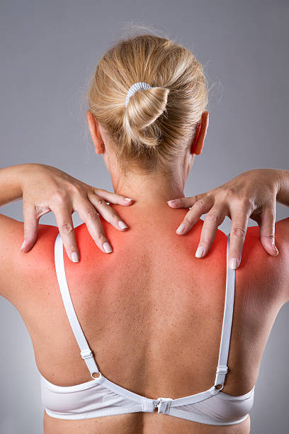 istock Woman with pain in shoulders with red dot 544795340