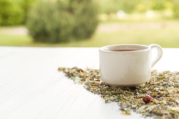 istock Cup of tea on table with herbs 544795844