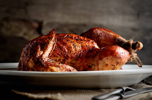 istock grilled chicken on an oval platter, vintage knife and fork 544795994