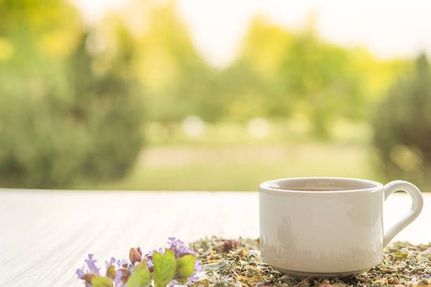 istock Cup of tea on table with herbs 544796416