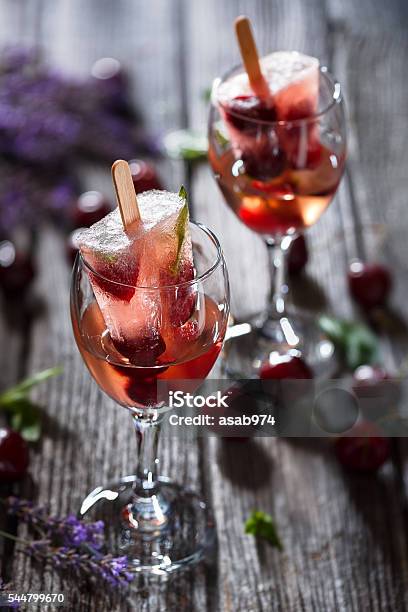 Rosé Wine Cocktail With Rosé Wine Cherries Basil Popsicles Stock Photo - Download Image Now