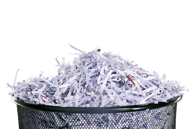 Leaving no shred of evidence Studio shot of shredded paper in a dustbin against a white background shredded stock pictures, royalty-free photos & images