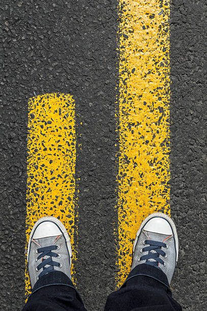 istock Standing on yellow street lines 544801358