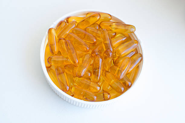 istock Bright yellow fish oil omega 3 nutritional supplements 544801472