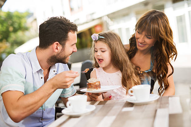istock Young loving family having fun in a cafe eating cake. 544802400