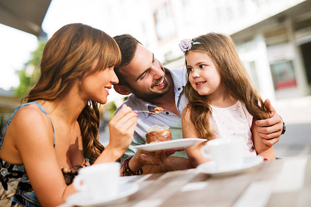 istock Young loving family having fun in a cafe eating cake. 544802458