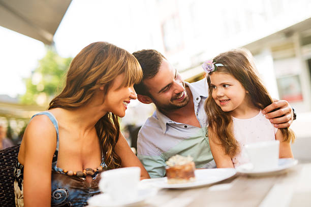 istock Young loving family having fun in a cafe eating cake. 544802528