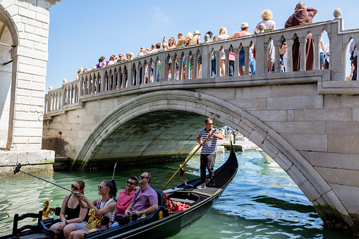 Venice, Italy - June 6, 2016: Gondola and crowd of people near the Bridge of Sighs on Riva degli Schiavoni in Venice Italy at day.