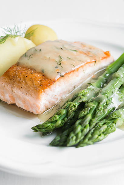 istock Grilled salmon with boiled potatoes and asparagus on white plate 544802728