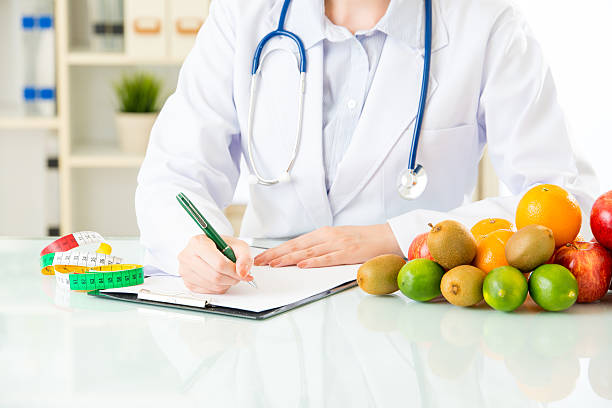istock Young asian nutritionist doctor writing diet plan 544804014