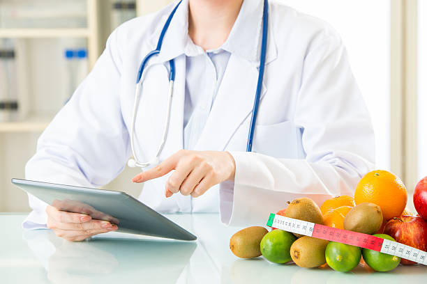 istock Young asian nutritionist doctor using digital tablet 544804158