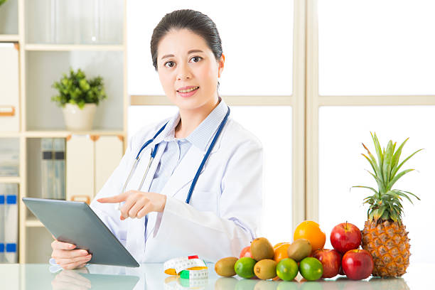 istock Young asian nutritionist doctor using digital tablet 544804222