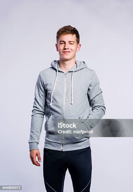 Boy In Gray Sweatshirt Young Man Studio Shot Stock Photo - Download Image Now - Sweatshirt, Teenager, Men