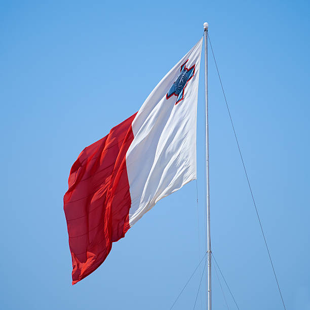 флаг мальты развевается над постом кастилии в биргу. - national flag flag global communications sky стоковые фото и изображения