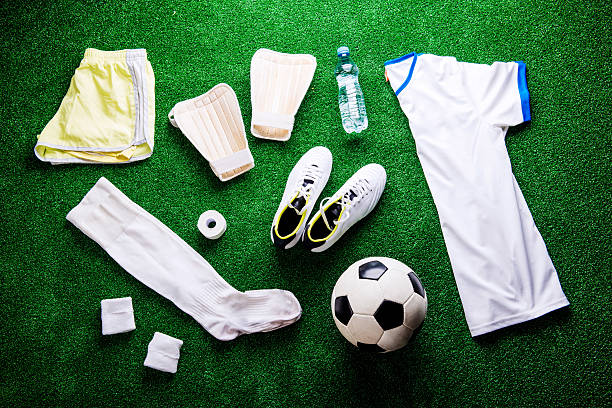 istock Soccer ball,cleats and various football stuff against artificial 544810302