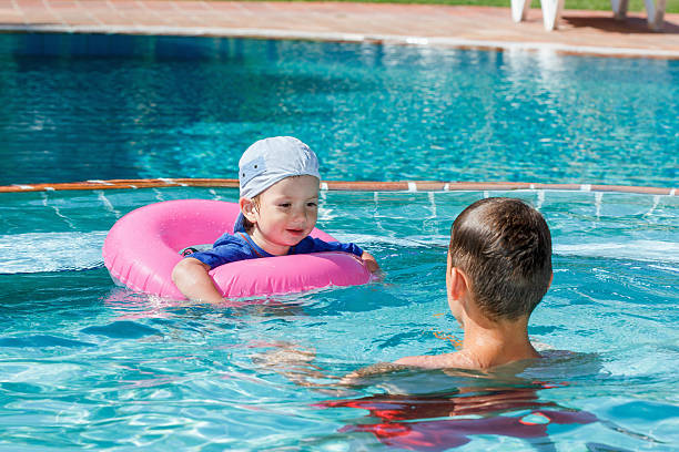istock Two brothers playing in the pool 544810410
