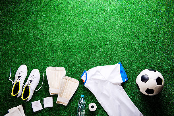 istock Soccer ball,cleats and various football stuff against artificial 544810444
